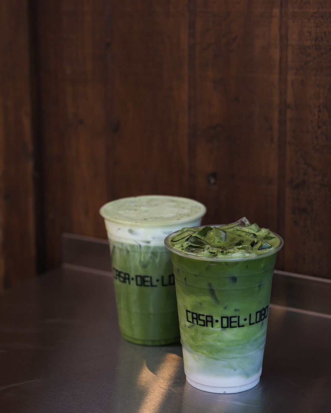 Two iced matcha drinks in Casa Del Lobo cups